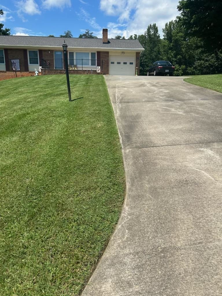 Clean, sharp lawn edging along a driveway in Wilkes County, NC