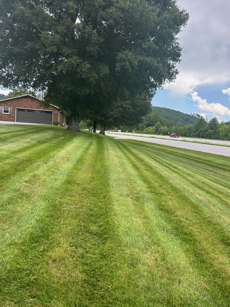 Crisp striped lawn mowing with a Blue Ridge foothills mountain view near Wilkesboro, NC
